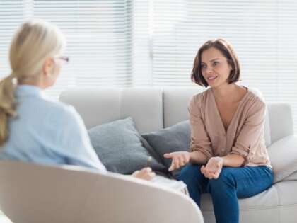 A woman and a therapist discussing California mental health statistics.